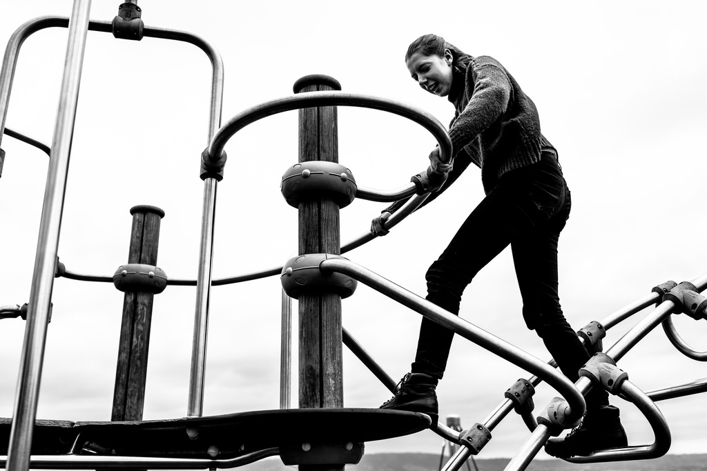 woman on playground black and white photo