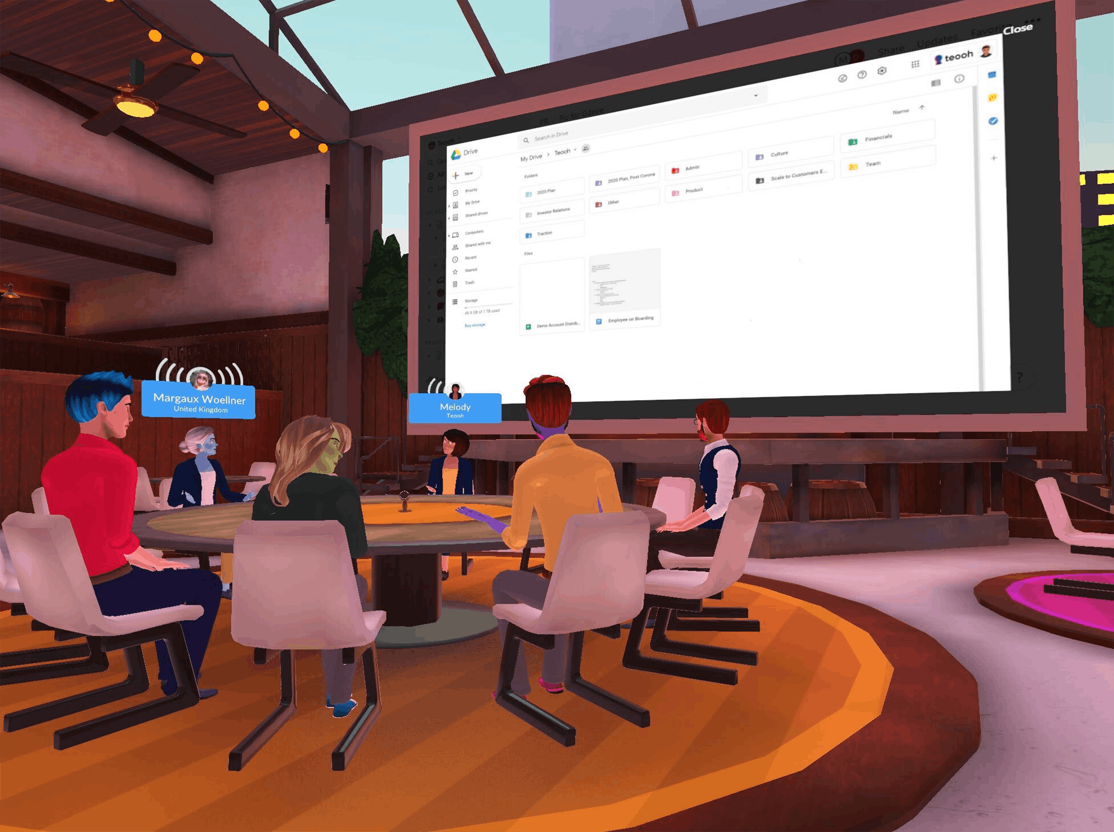 A virtual meeting at a round table with a giant screen in a small conference room via the Teooh app.