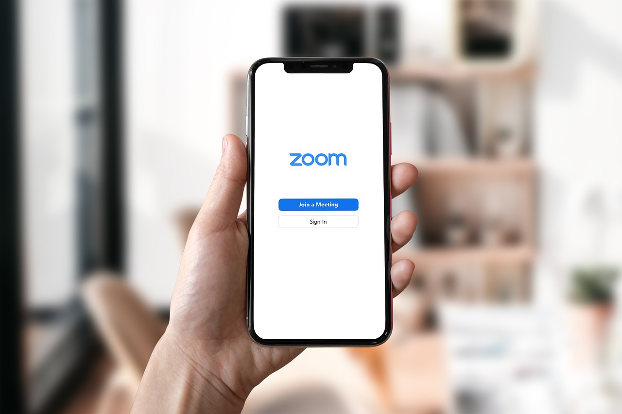 A mobile phone displaying Zoom's logo
