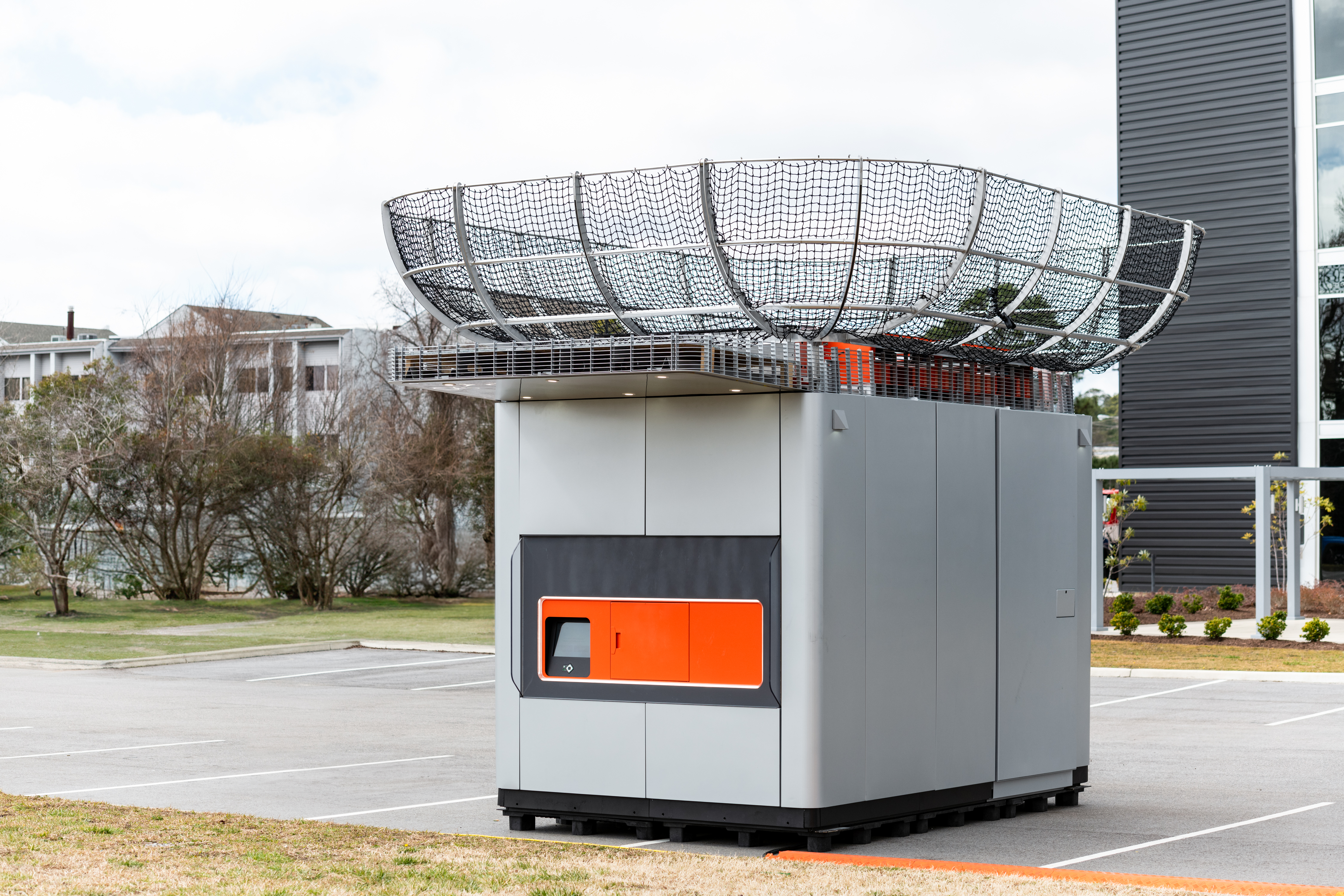 A DroneUp DBX robotic storage kiosk for package pickup and delivery