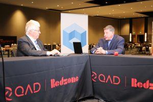 Paul Gillin and Scott Hebner keynote analysis the QAD Champions of Manufacturing 2025 event, highlighting AI-powered factory operations.